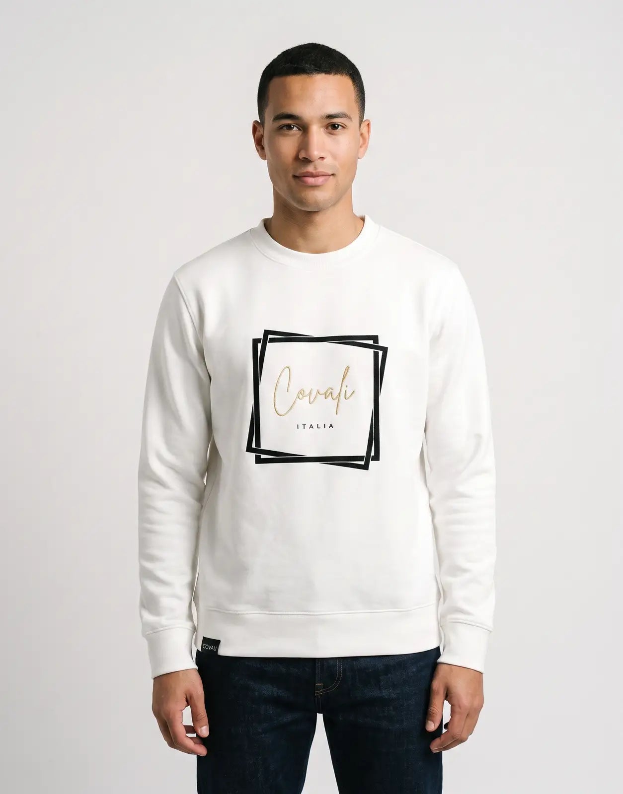 White Covali Oro Sweatshirt featuring a gold 'Covali ITALIA' script logo framed in a black square on the front. Long-sleeved
