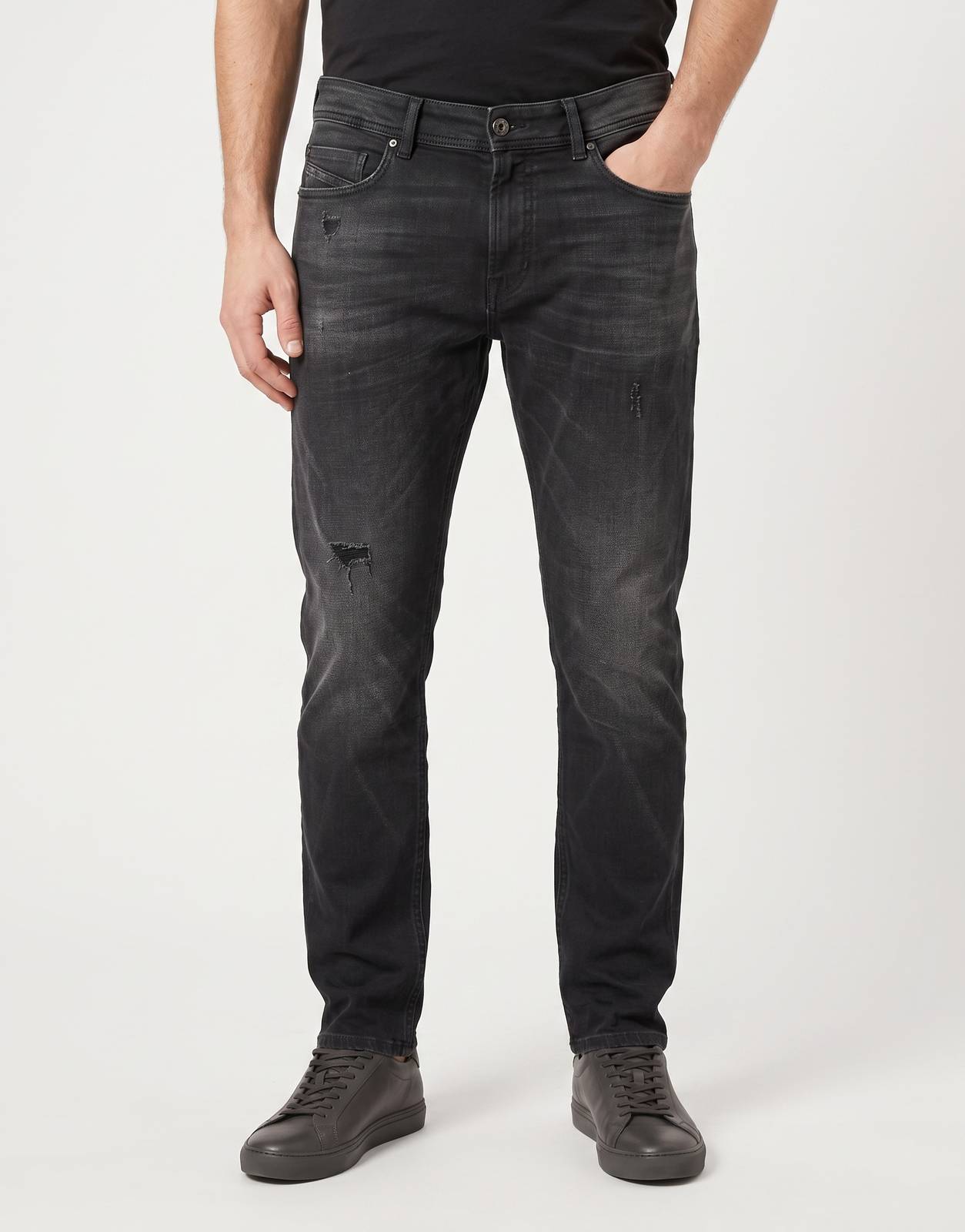 Front view of Diesel 1979 Sleenker men's distressed black denim jeans with rips, suitable for casual wear.