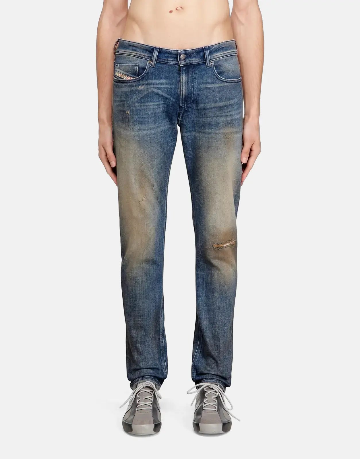 Diesel 1979 Sleenker skinny fit denim jeans for men in a distressed blue wash, shown full body on a model.