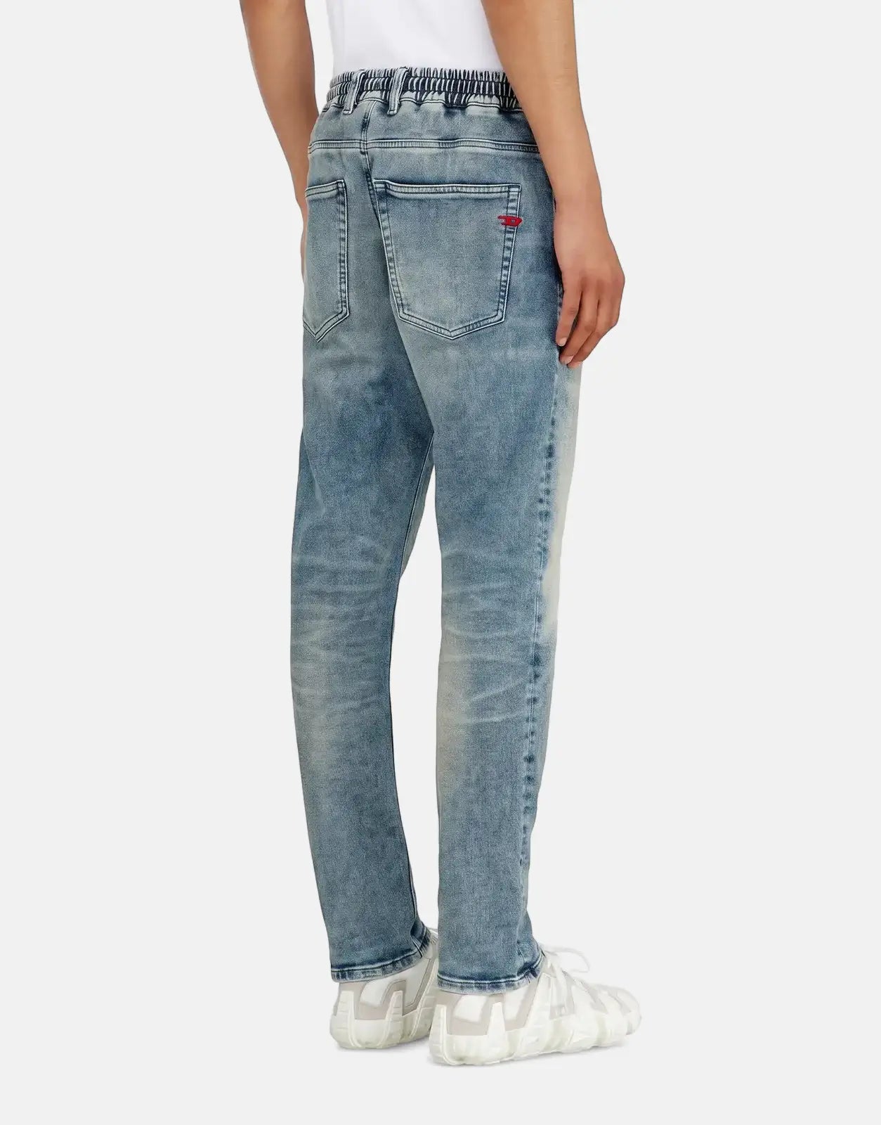 Light blue Diesel 2032 D-Krooley B Jogger jeans, elastic waist, worn by a man, viewed from the back.