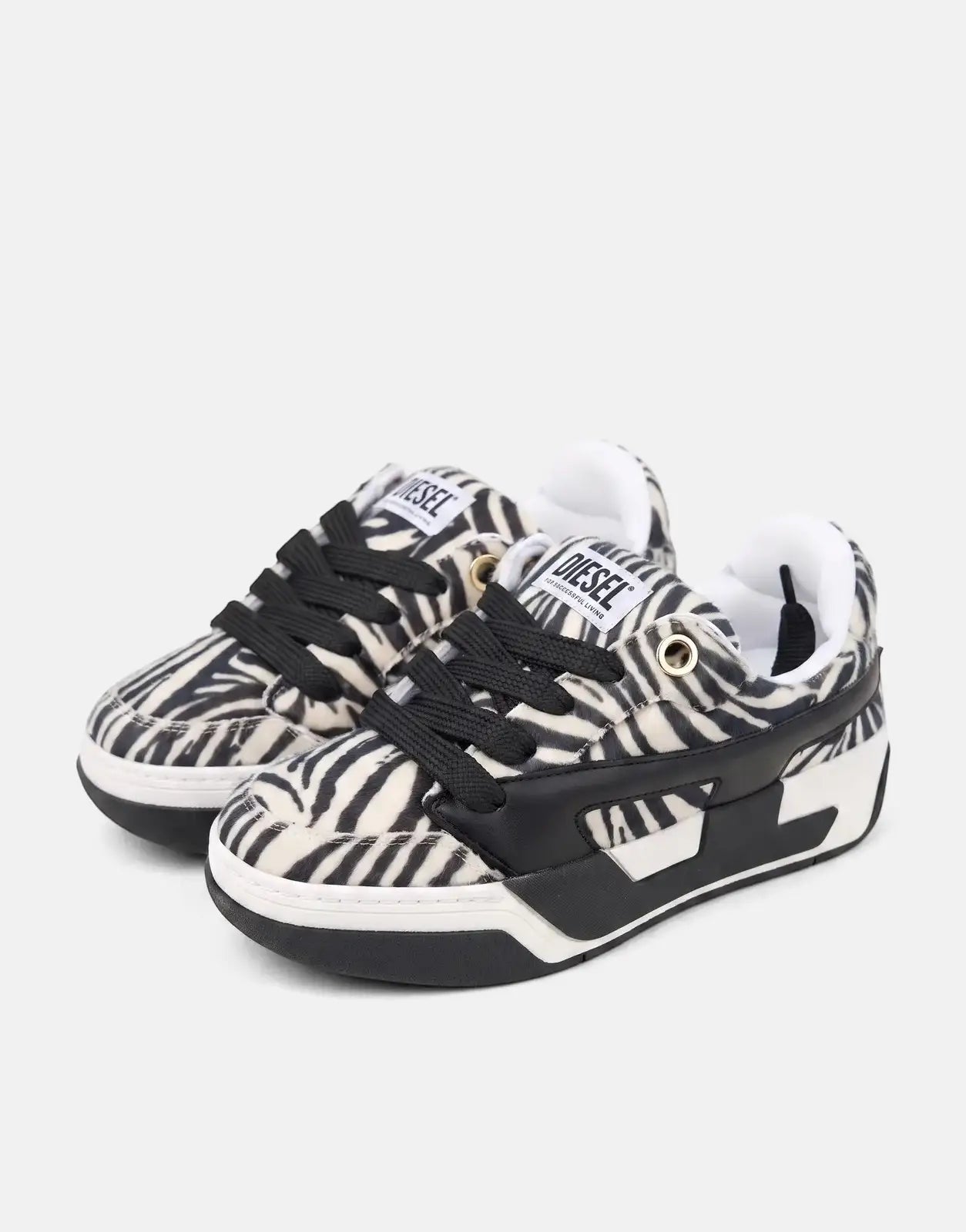 Diesel D-Ollie Low Sneaker in black and white zebra print, featuring black laces and a chunky sole, shown from a side view.