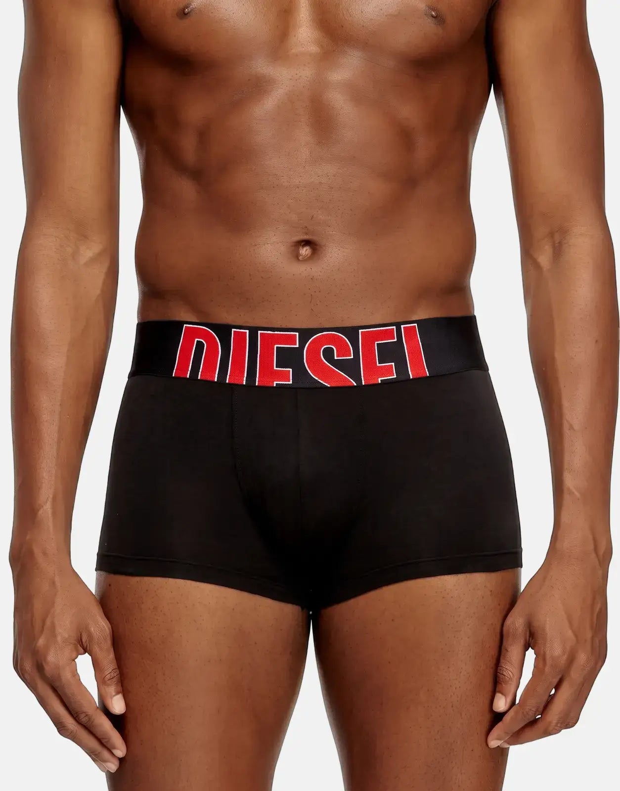 Close-up of a man wearing black Diesel Damien D Pop boxer shorts with a red logo waistband.