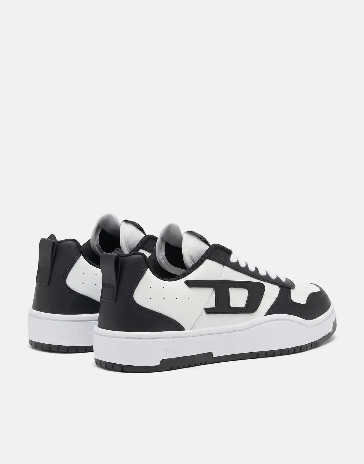 Diesel S-Ukiyo V2 Low Sneakers in black and white, featuring a low-top design, shown from a rear-side view.