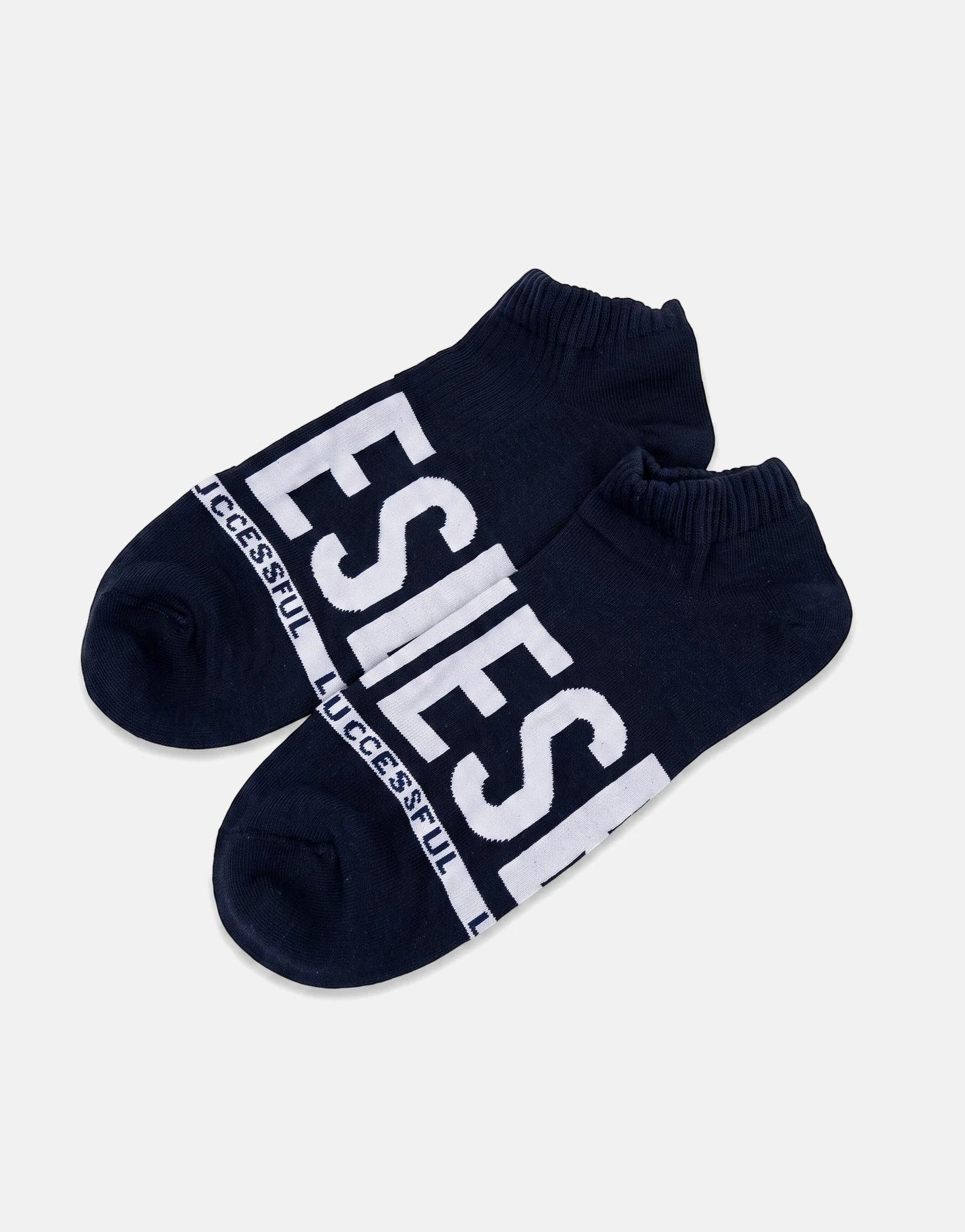 A pair of dark blue Diesel SKM Gost ankle socks with white 'SUCCESSFUL' and 'DIESEL' branding, laid flat on a white