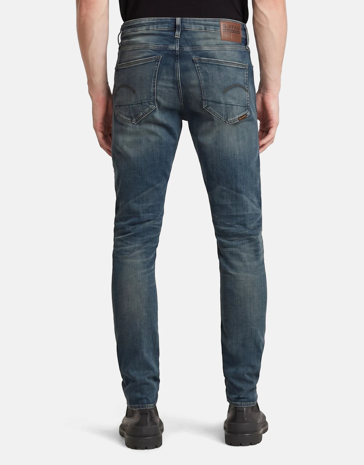 G-Star RAW 3301 Slim Faded Worker Blue Jeans on a person, shown from the back, highlighting the slim fit and distressed wash.