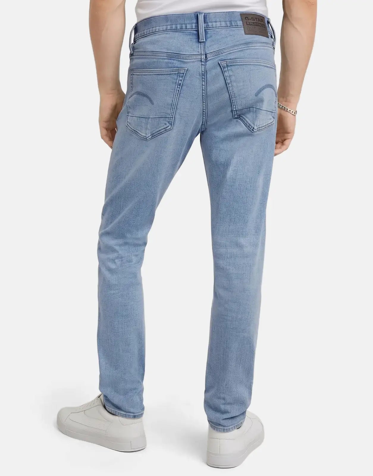 Back view of G-Star RAW 3301 Slim Lt Aged Men's Jeans, featuring a light aged wash and slim fit with white sneakers.