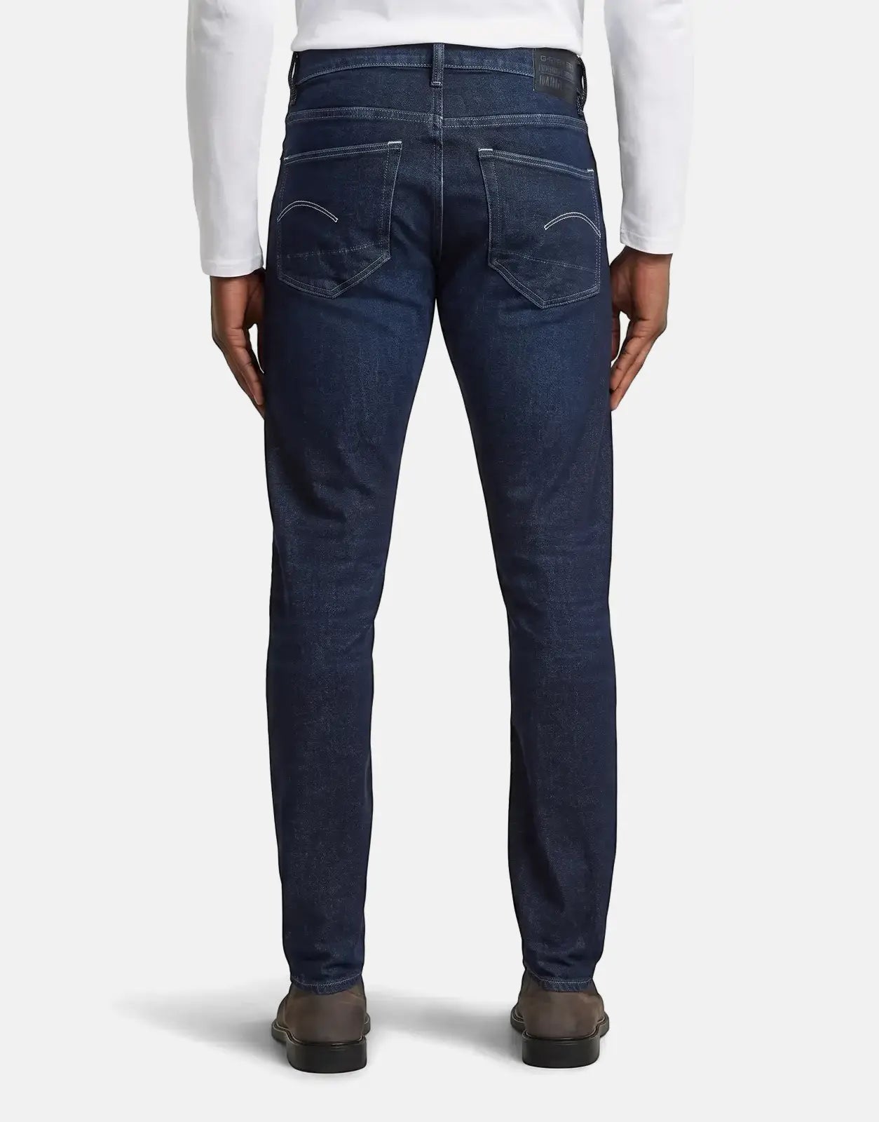 Men's G-Star RAW 3301 Worn in Deep Marine dark blue jeans, shown from the back, with a white long-sleeve shirt.