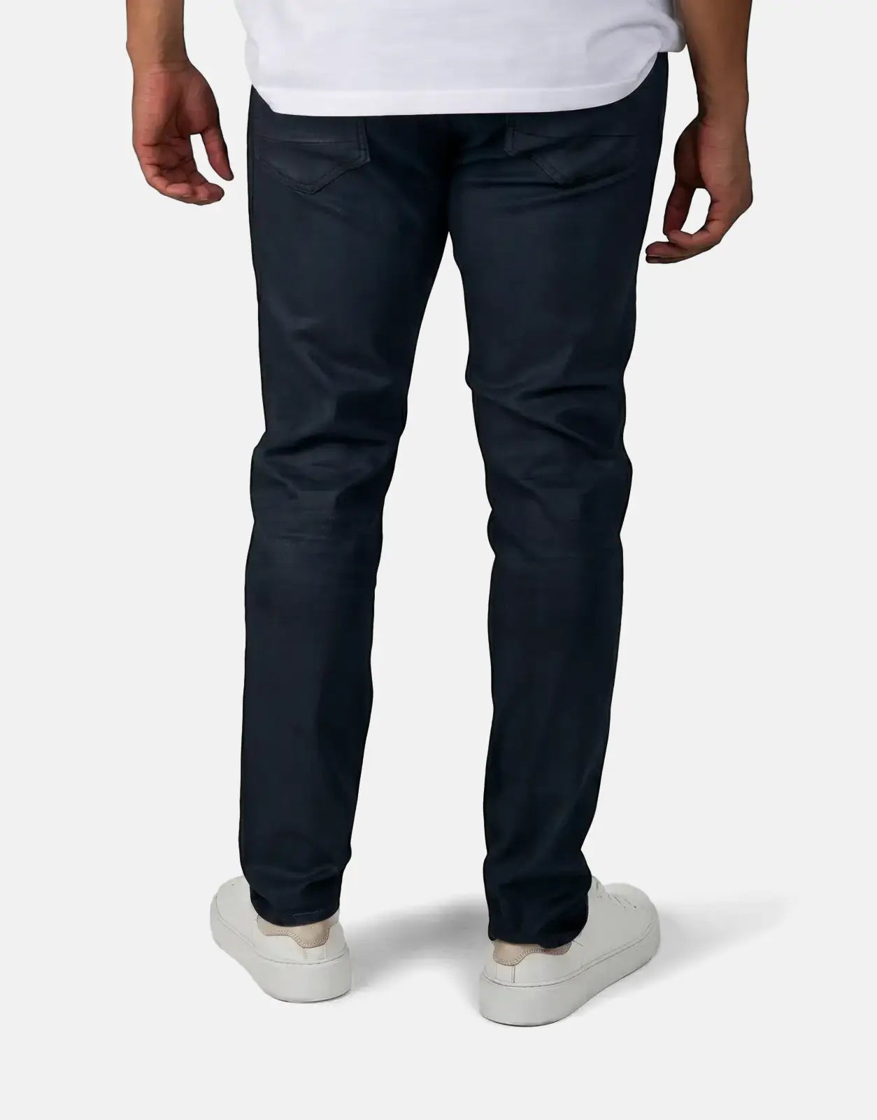G-Star RAW Aged Slim Blue Cobler Jeans, dark wash, worn by a person from the back, paired with white sneakers.