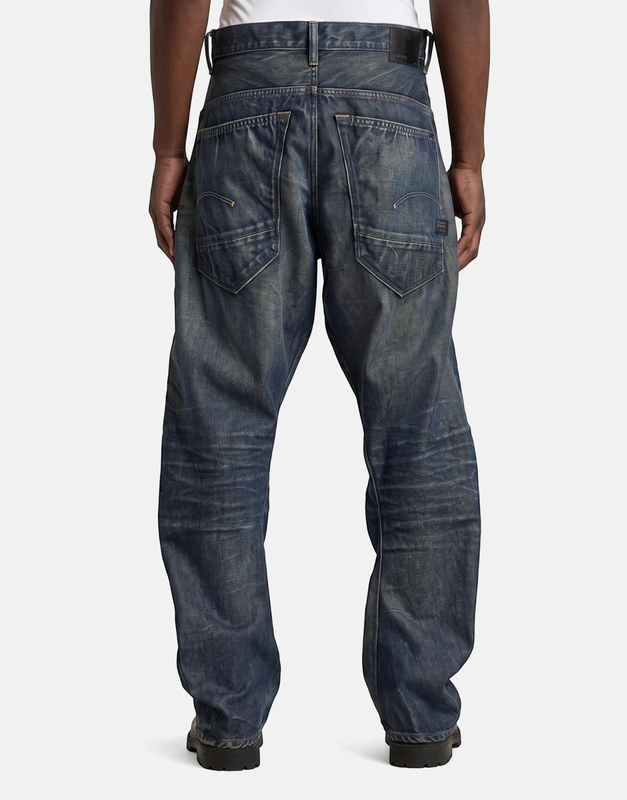 G-Star RAW Arc 3D Loose Raw Vintage Jeans in dark blue distressed denim, shown from the back on a person.