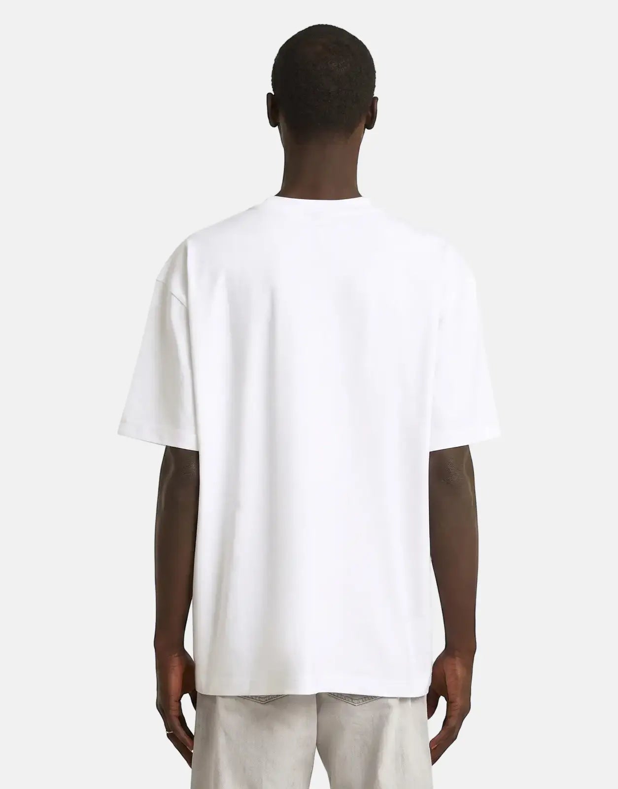 Rear view of a man wearing a G-Star RAW HB Badge Relaxed White T-Shirt, showcasing its relaxed fit and design.