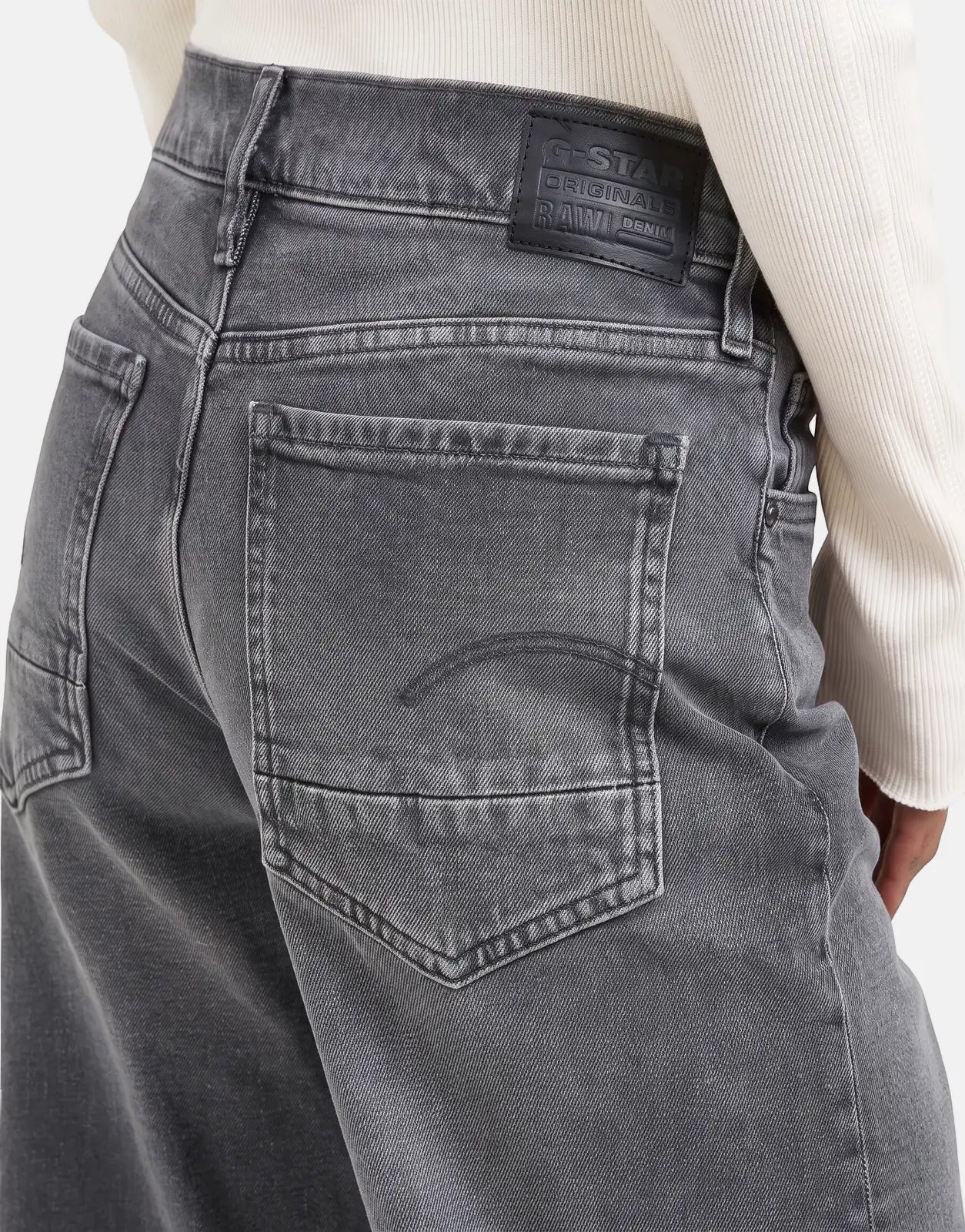 Close-up back view of G-Star RAW Judee Loose Faded Blade Jeans in a dark grey wash, featuring detailed pockets and brand