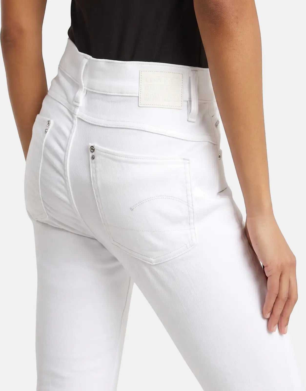 Close-up back view of a person wearing G-Star RAW Lhana Skinny Paper White Jeans, showcasing the brand patch and pocket