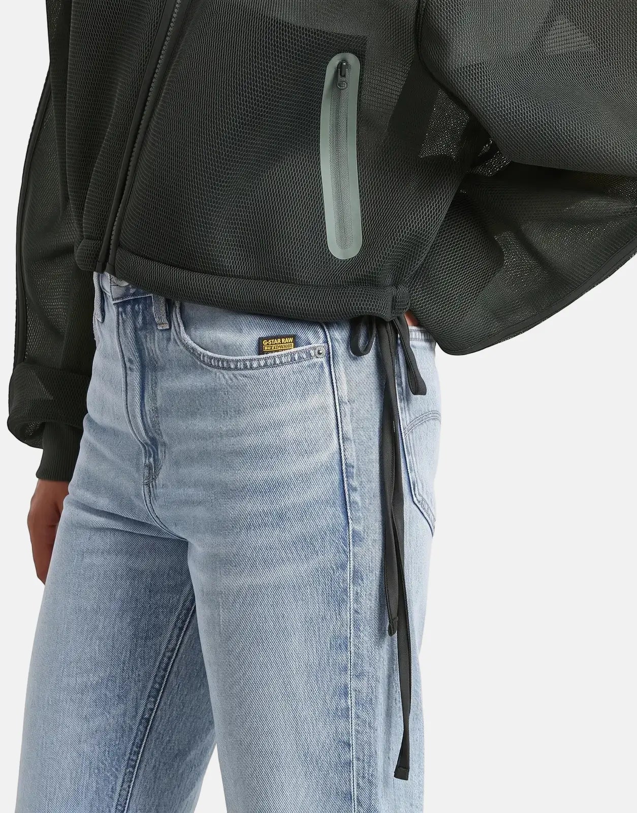 G-Star RAW Meshy Binding Orphus Jacket in dark green, worn by a model with light wash jeans, close-up shot.