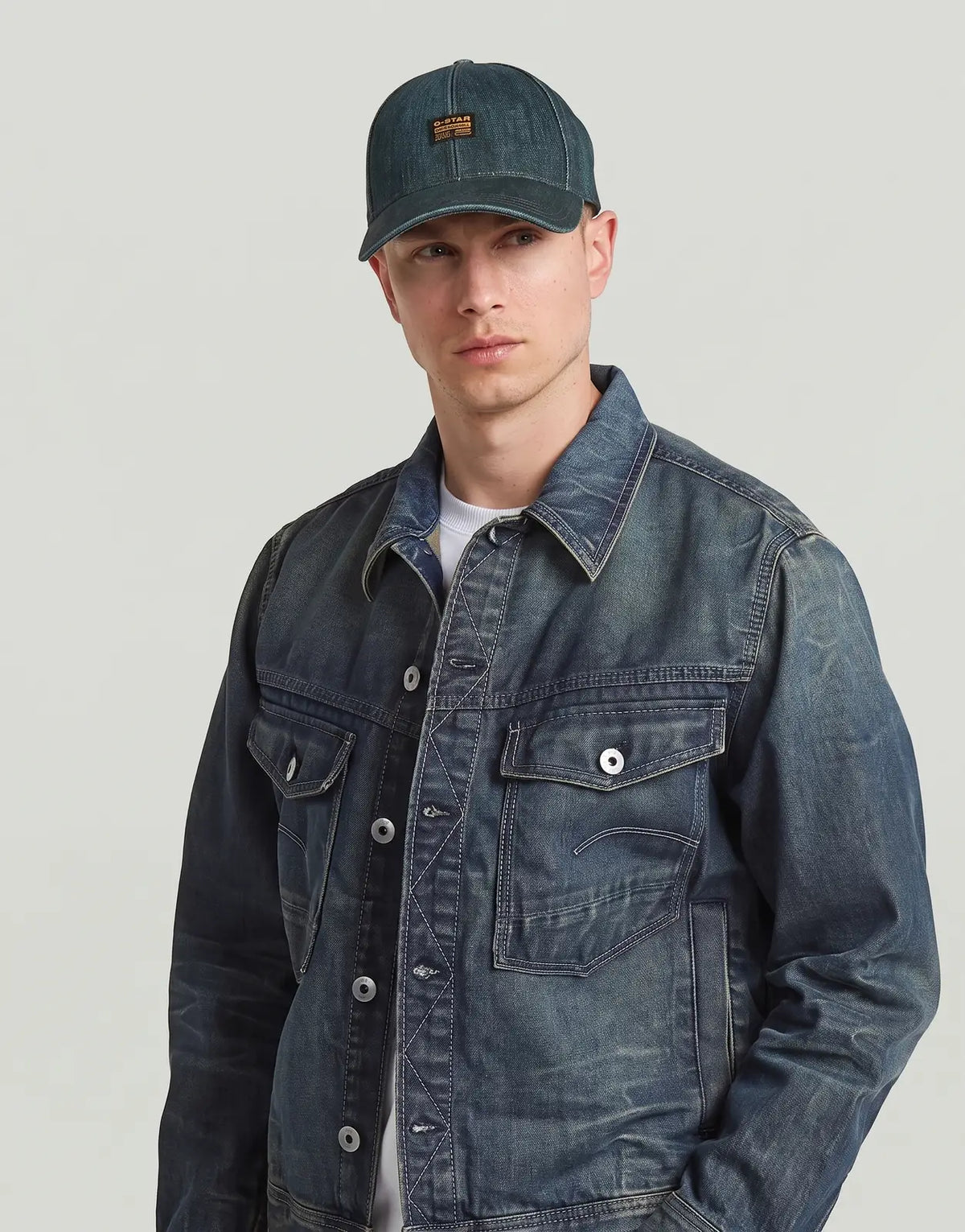 G-Star RAW Originals Baseball Cap Antique Crossover, a blue-green distressed denim cap with a logo patch, worn by a male