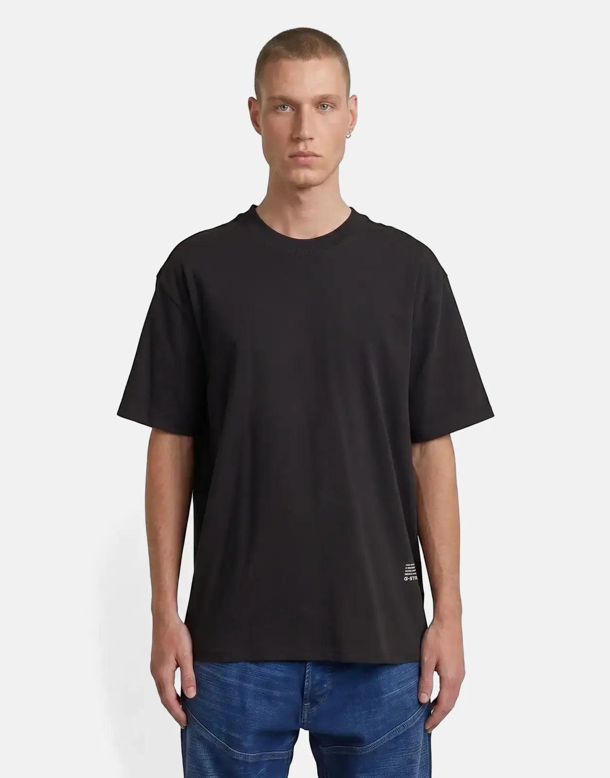 G-Star RAW relaxed-fit black t-shirt with a back applique, worn by a male model in blue jeans, front view.