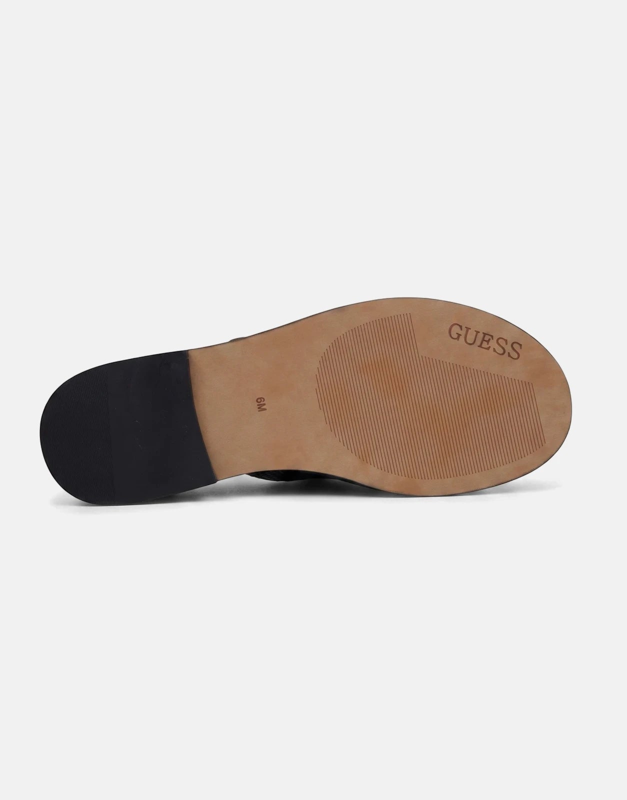 Close-up view of the sole of a black Guess Graysie AFW sandal, featuring the Guess logo and size 6M.