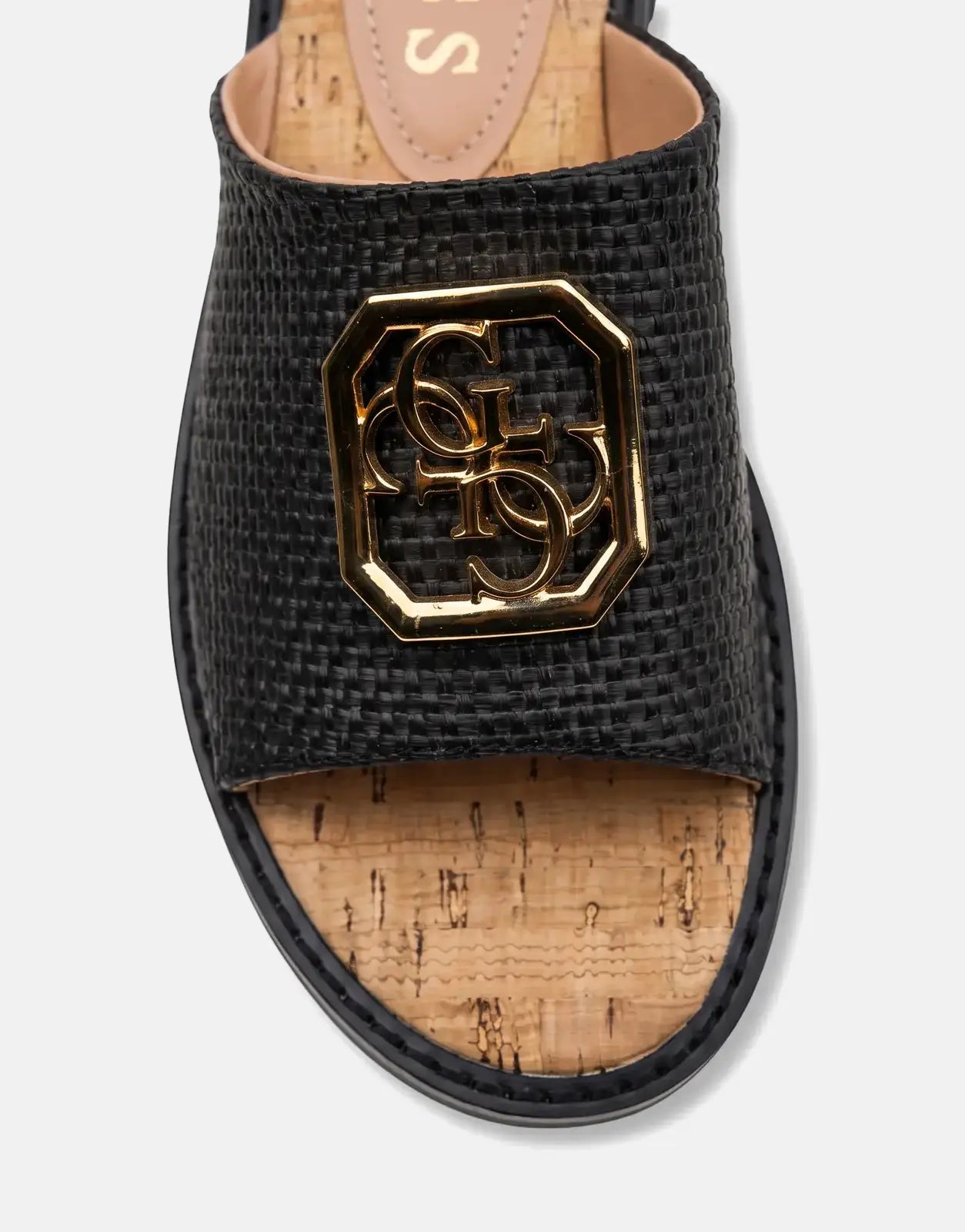 Close-up of a black Guess Graysie AFW sandal featuring a textured strap with a gold Guess logo and a cork footbed.
