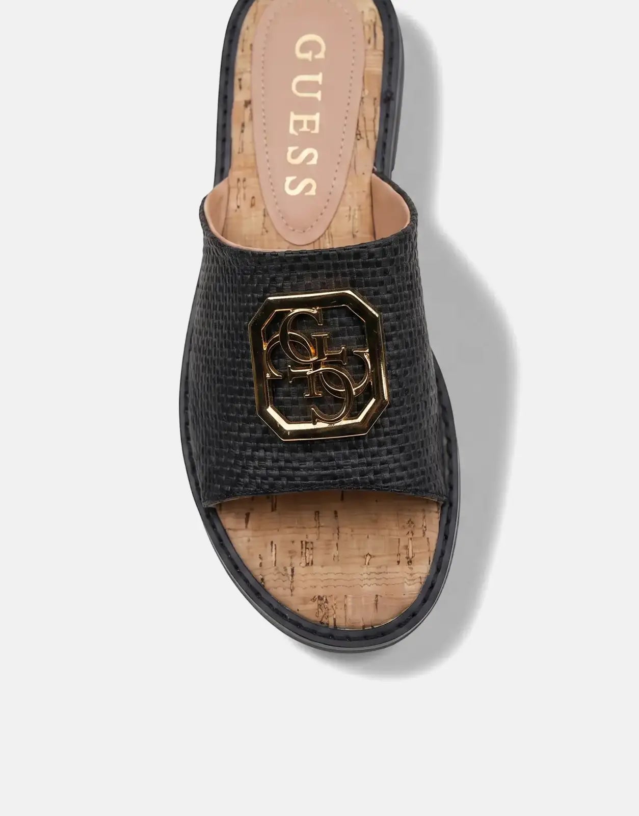 Black Guess Graysie AFW sandal with a woven strap and cork sole, featuring gold Guess logo hardware, presented from an