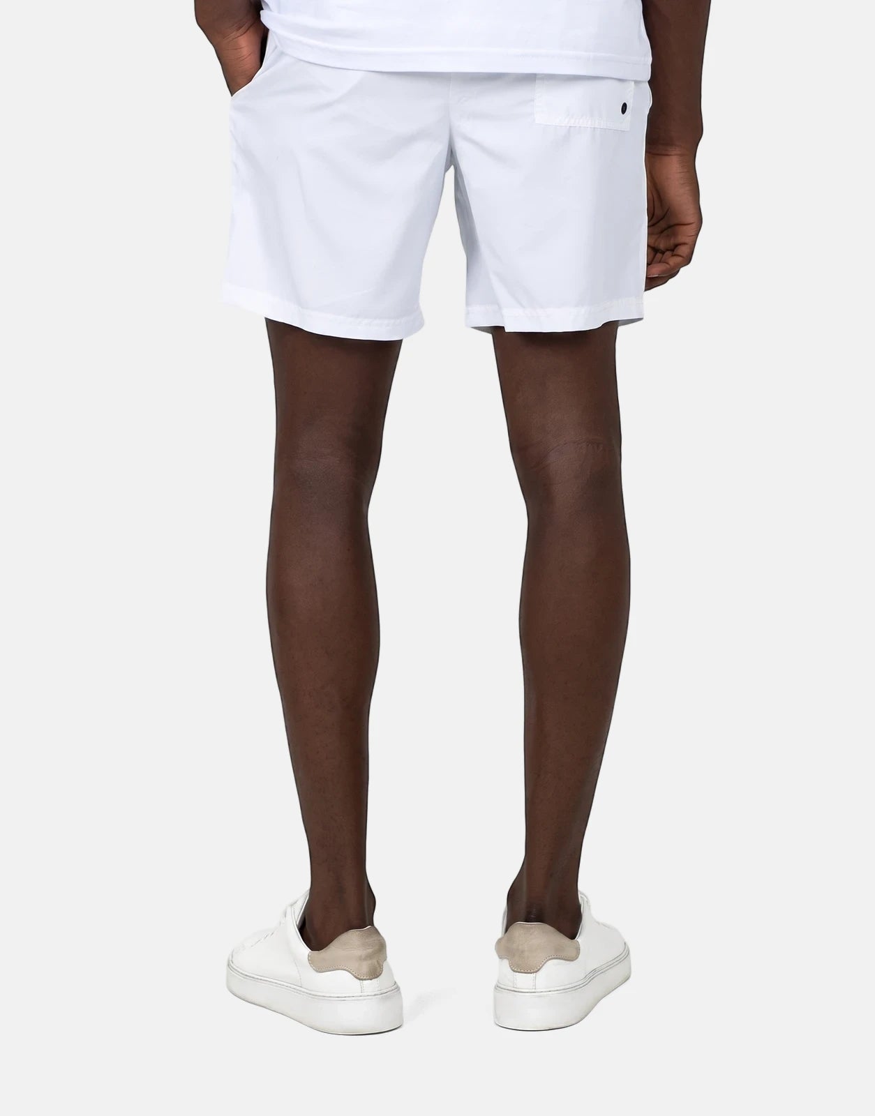 Les Hommes Colour White Swim Shorts in white with back pocket and button detail, shown from the back.