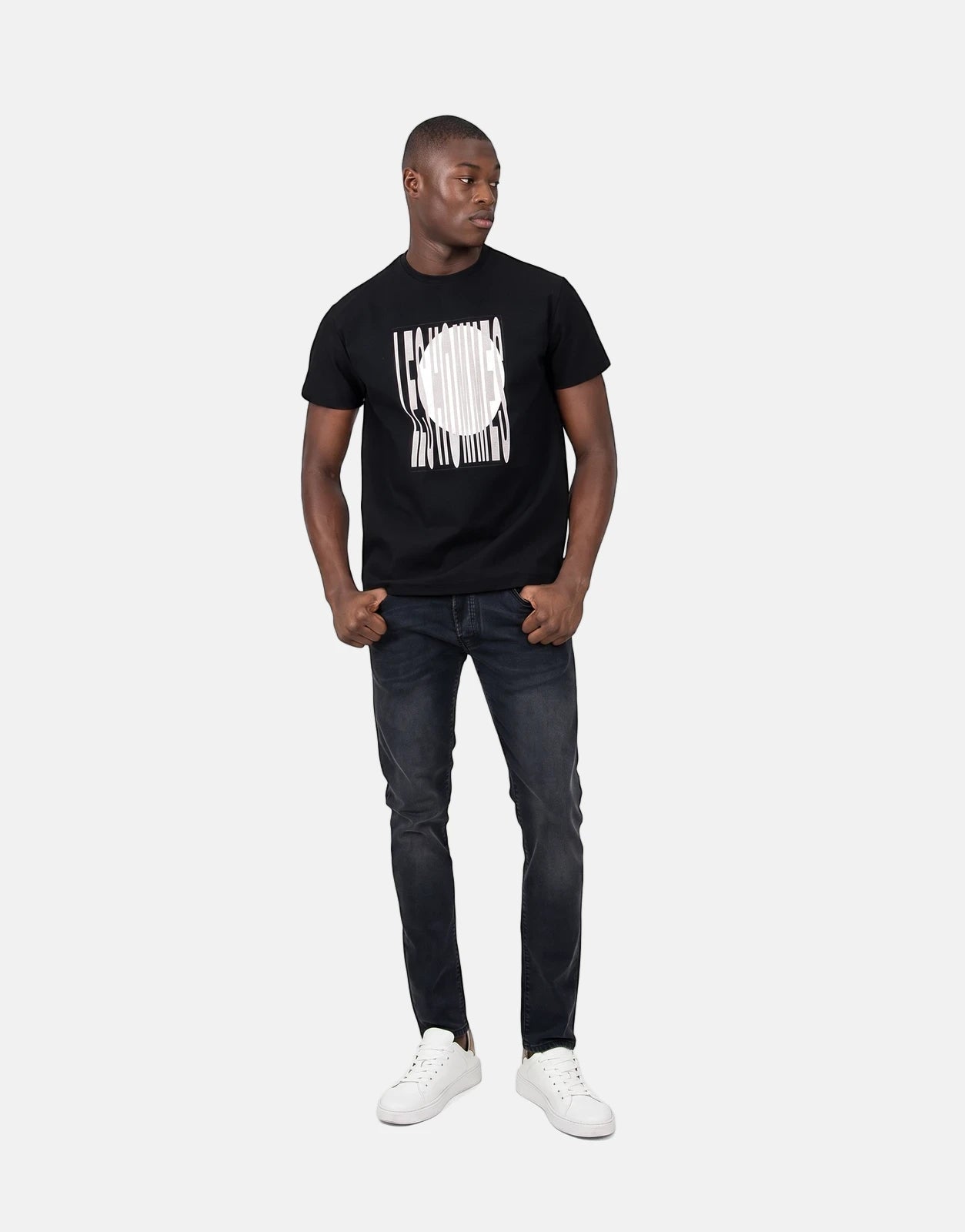 Les Hommes Logo Print Black T-Shirt featuring a white circular logo with striped background on a black cotton tee.