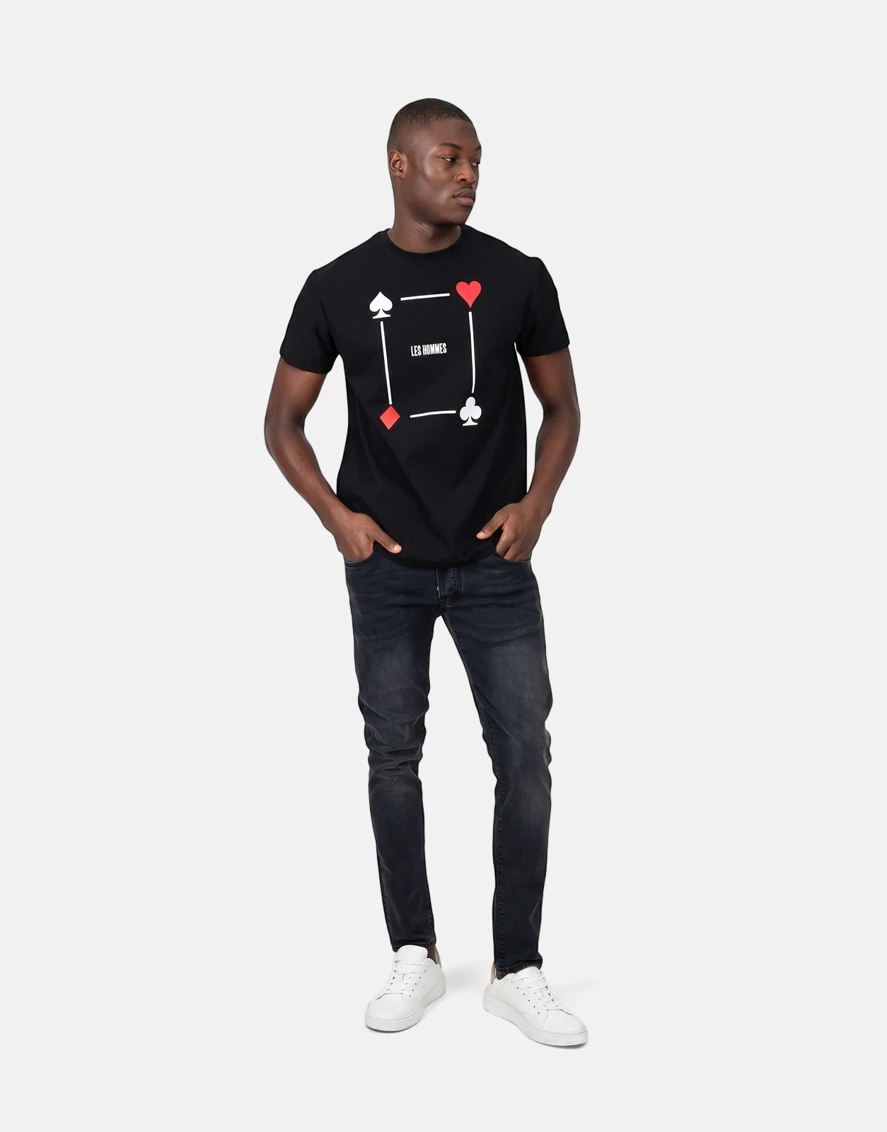 Men's Les Hommes black t-shirt featuring a distinctive poker card suit graphic print, paired with black jeans and white