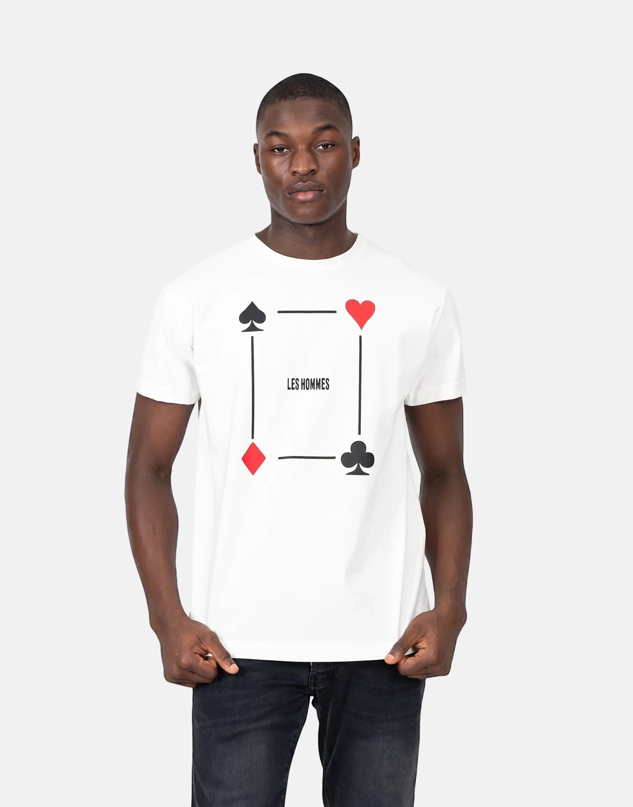 Les Hommes Poker Print White T-Shirt for men, featuring card suits and text, worn with black jeans.