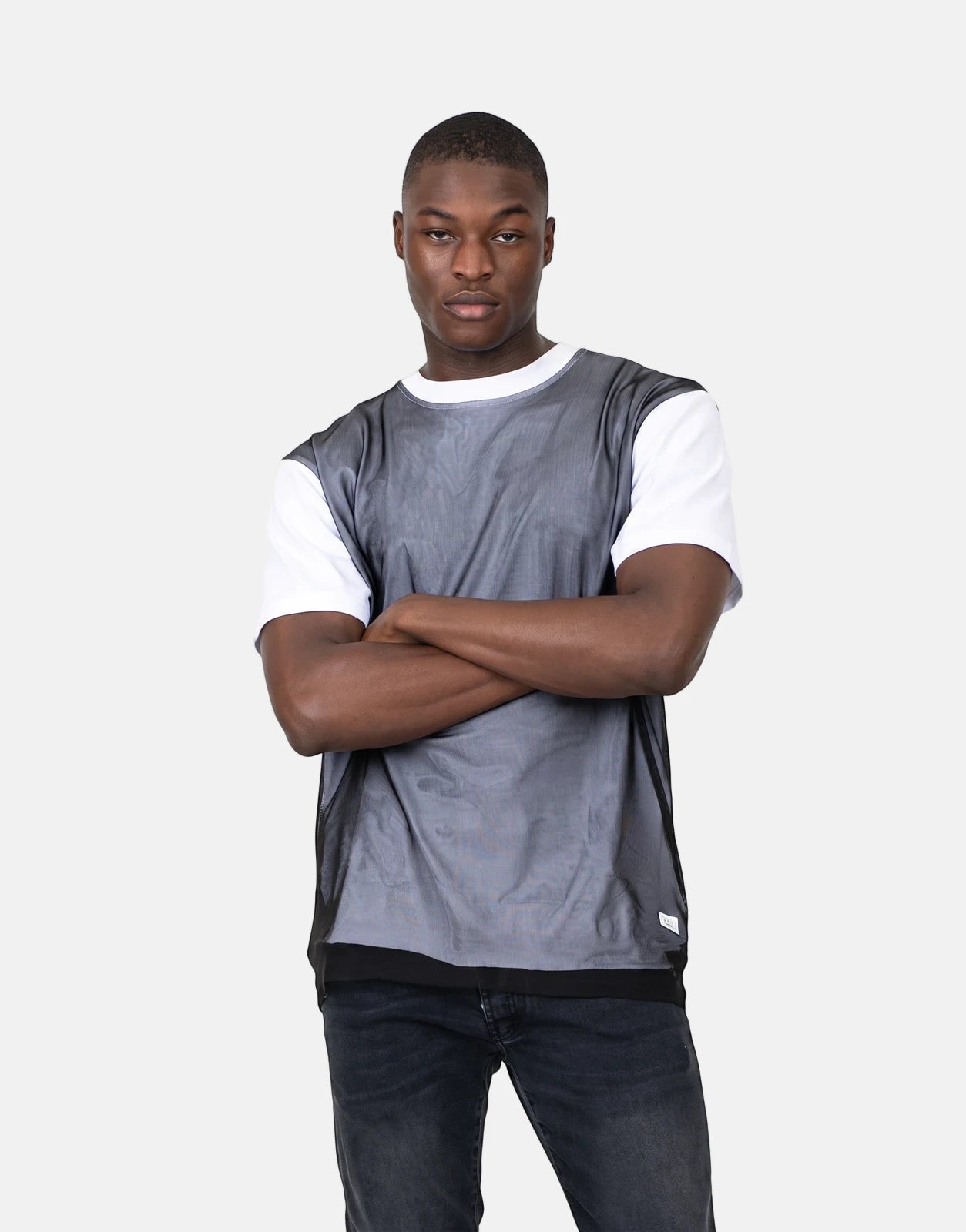 Les Hommes Tulle White T-Shirt worn by a male model, featuring a white short-sleeve base and a grey mesh overlay with black
