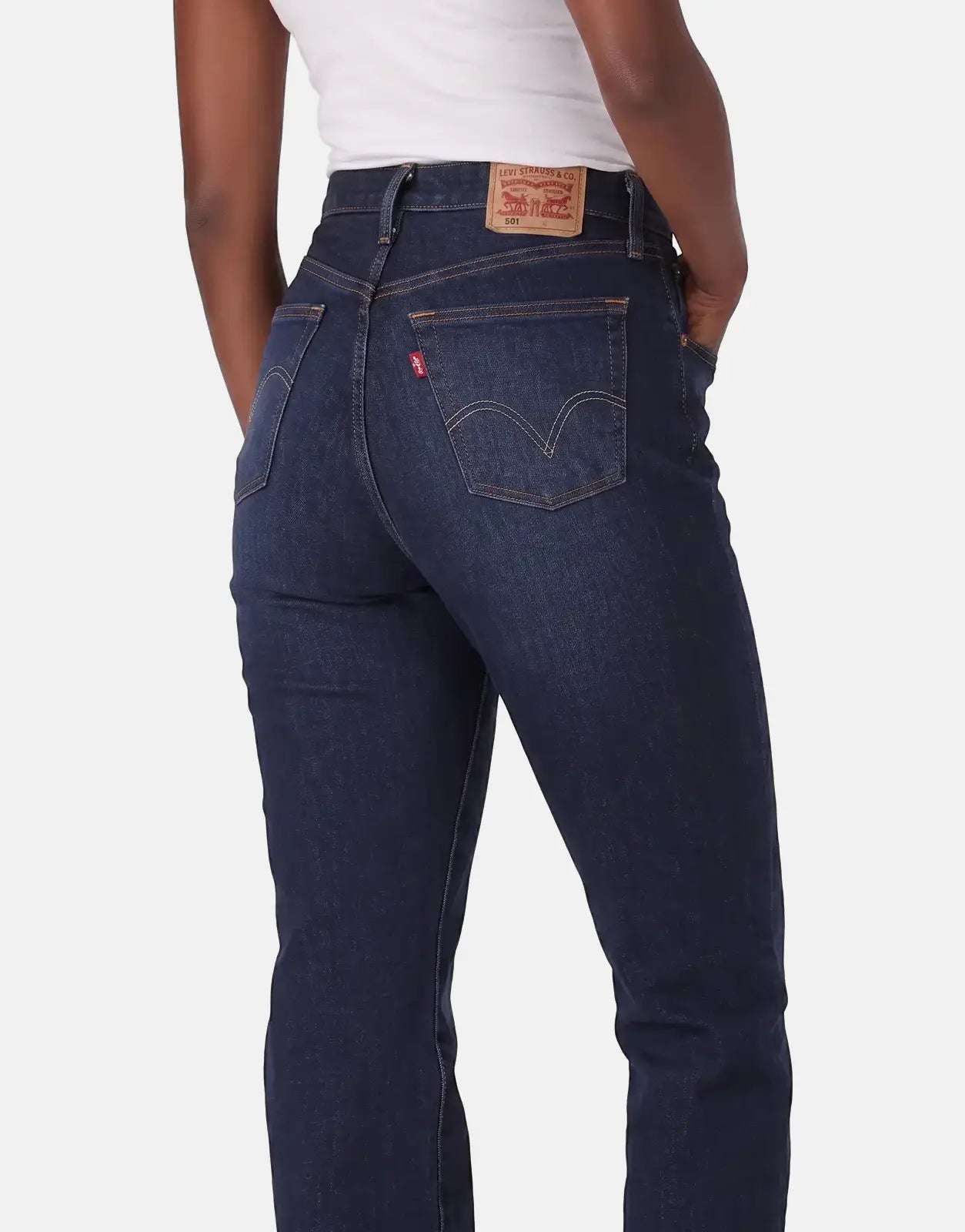 Levi's 501 Ladies Time Take dark blue high-waisted jeans, seen from the back on a model with hands in pockets.