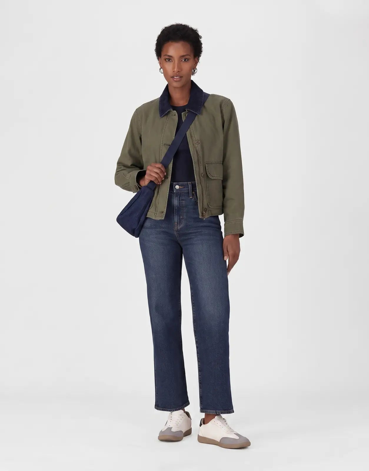 Dark wash Levi's 501 Women Array Away Jeans paired with an olive green utility jacket and white sneakers, modeled from the