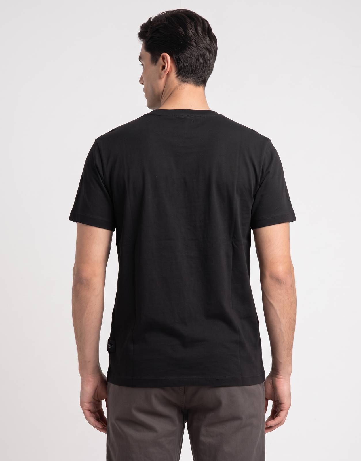 Men's Replay Side R-Logo black t-shirt, styled with grey trousers, viewed from the back on a male model.