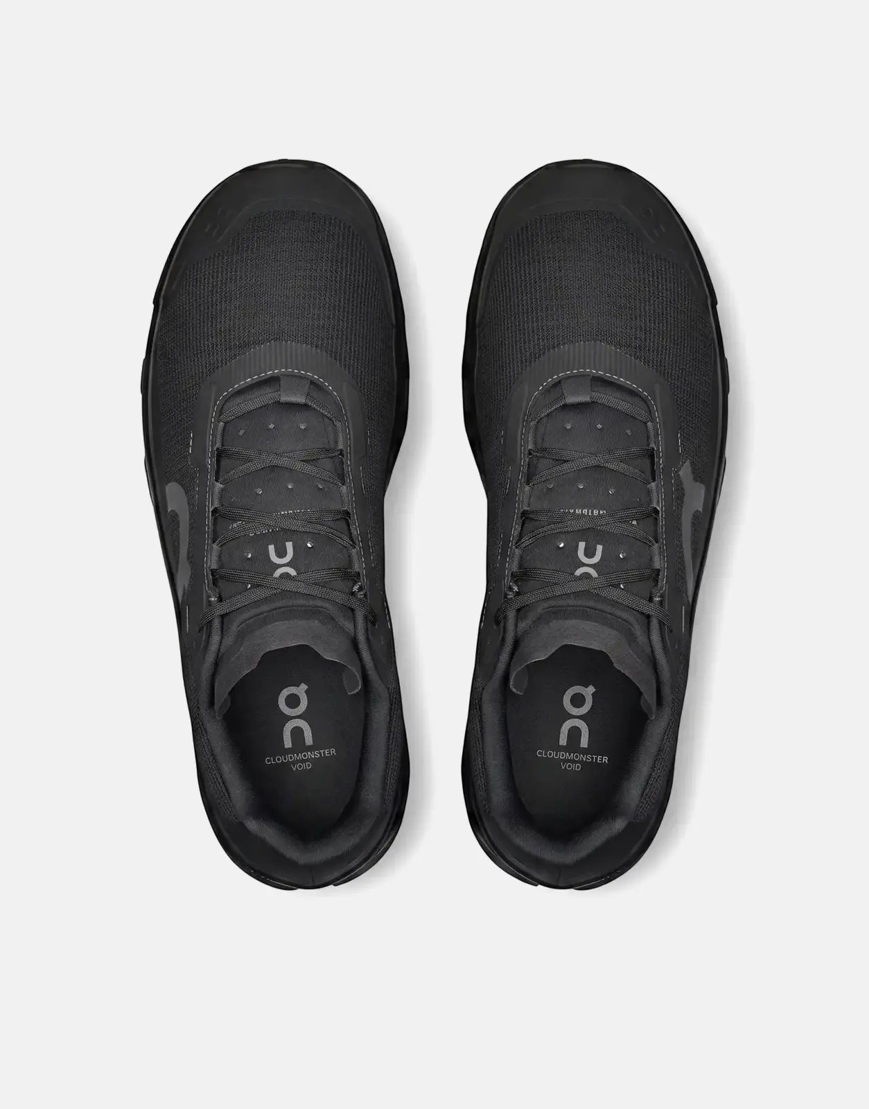 On Men's Cloudmonster Void black running sneakers, presented from a top-down view on a clean surface.