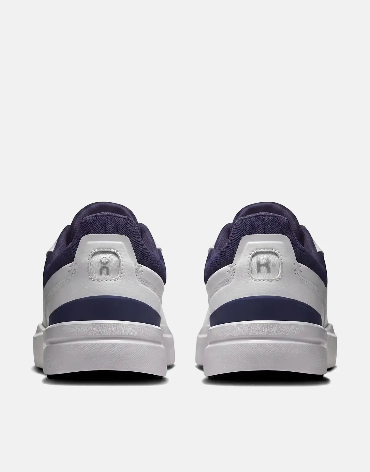 On Men's The Roger Advantage sneakers in white and midnight blue, shown from the rear view, highlighting the clean design.