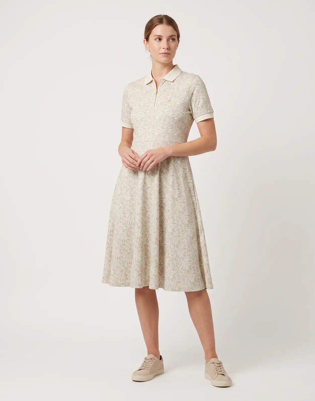 Polo Emily Fit & Flare Printed Multi Colour Golfer Dress, featuring a collared zip-neck and short sleeves, laid flat.