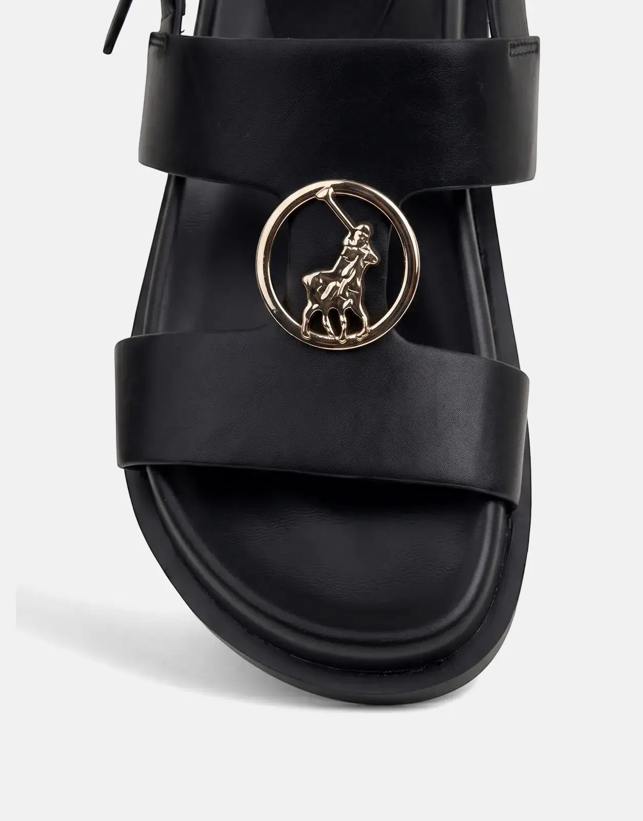 Close-up of a black leather Polo Moulded New Trim sandal, featuring a prominent gold Polo Ralph Lauren emblem on the strap.