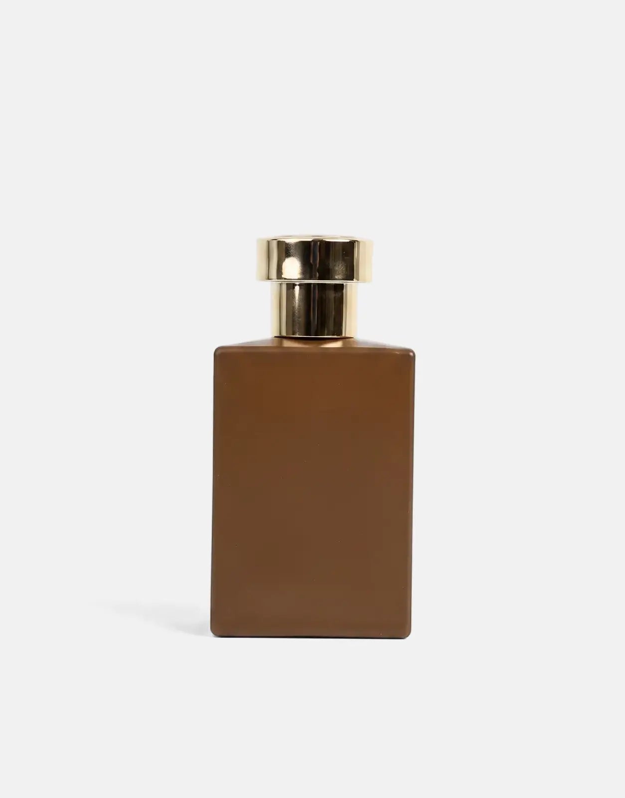 Pure Premium Intense Energie Perfume in a rectangular brown glass bottle with a shiny gold cap, studio shot.