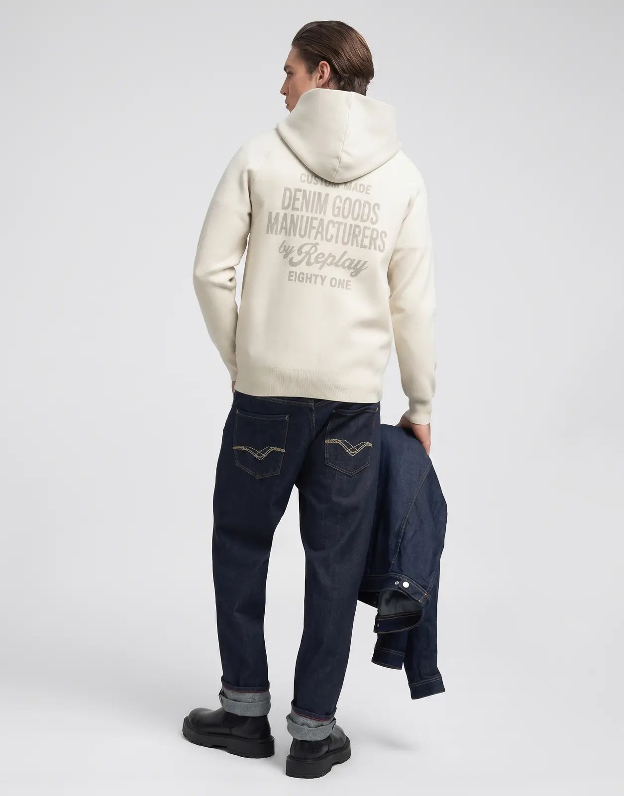 Replay men's cream knit hooded sweatshirt with 'Denim Goods Manufacturers by Replay' graphic on the back, modeled from