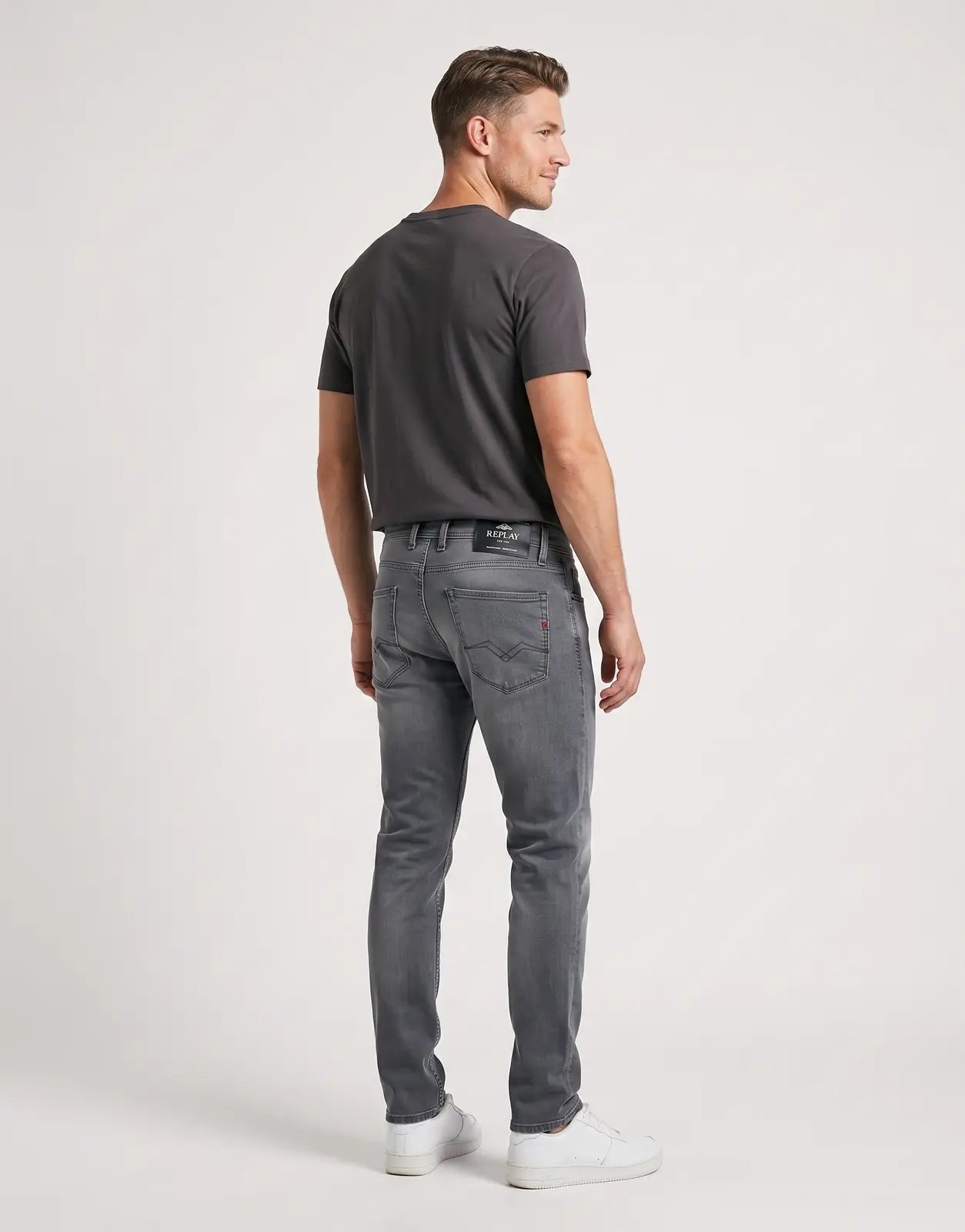 Replay Powerstretch Grey Jeans in a dark wash denim, featuring distinct back pocket stitching and branding, shown in a back