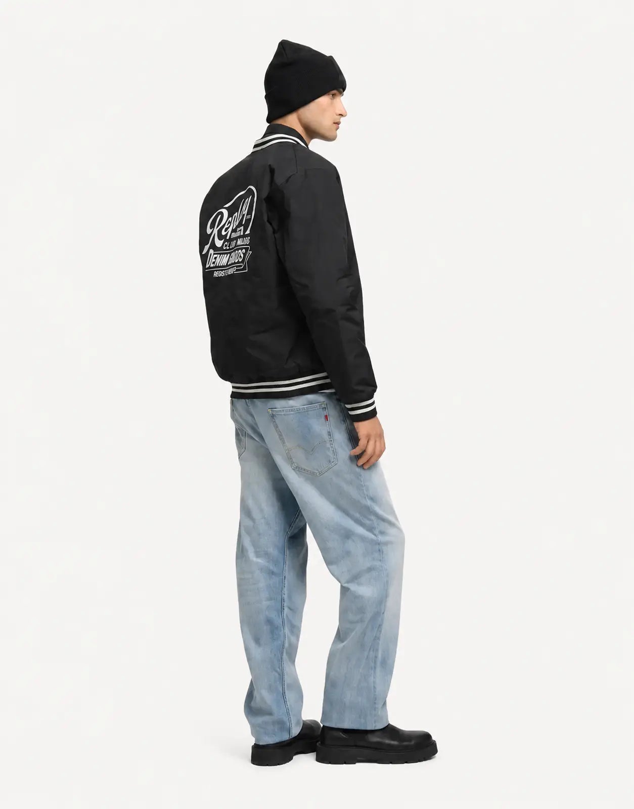Replay Varsity Black Jacket shown from the back, black bomber style with striped rib collar and cuffs and large logo print.
