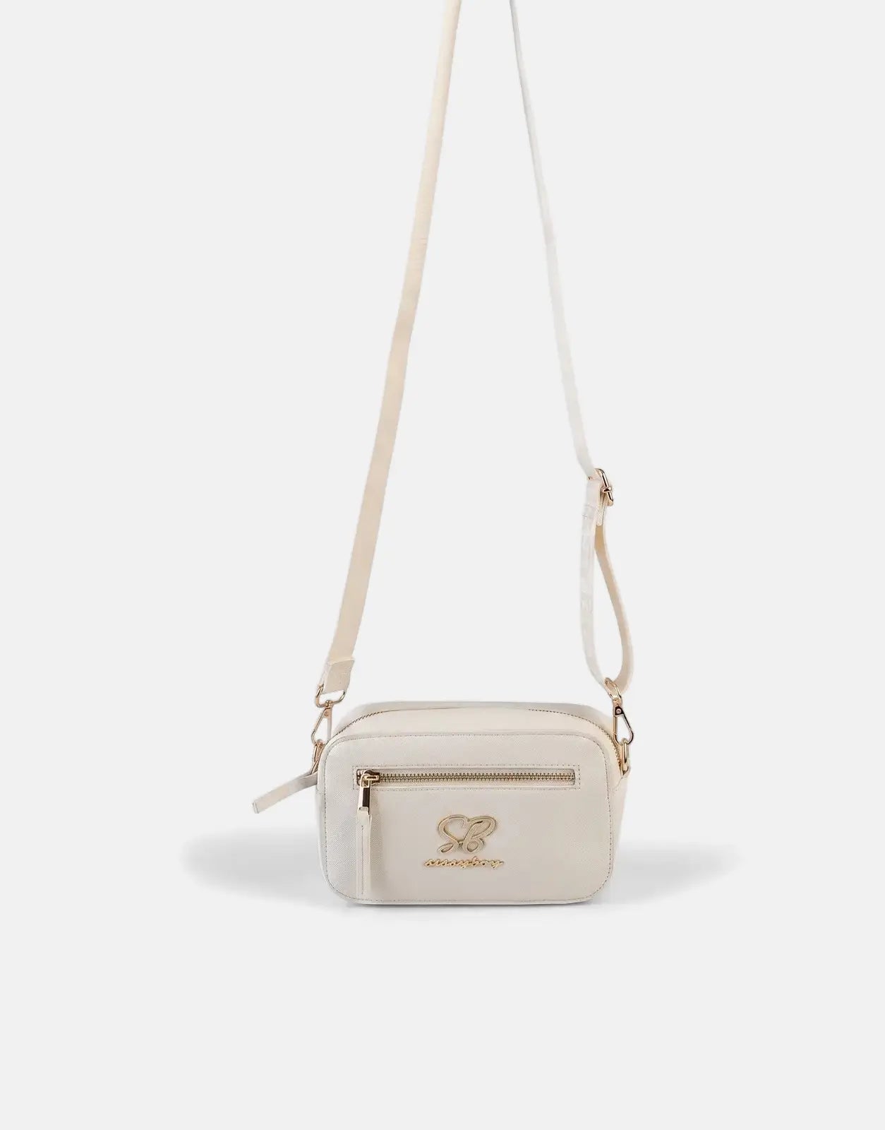 Sissy Boy Basic Cream Camera Bag with gold-tone hardware and adjustable shoulder strap, hanging in studio.