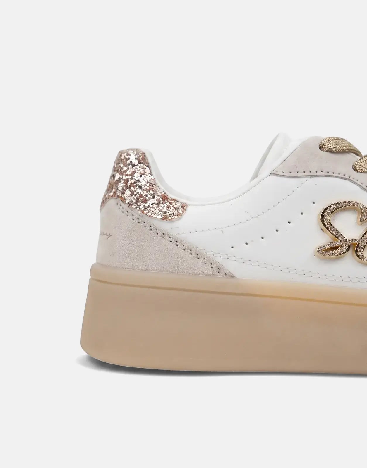 Close-up side view of Sissy Boy Blaine women's sneakers with a white upper, gold glitter heel tab, and an ornate gold 'SB'