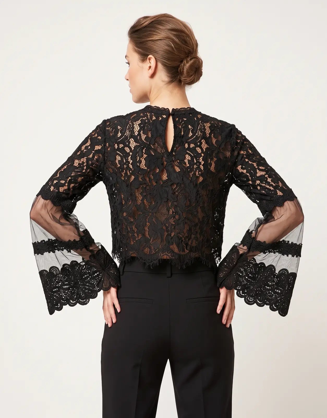 Back view of a Sissy Boy In Your World black blouse made of intricate lace and sheer mesh fabric with bell sleeves.