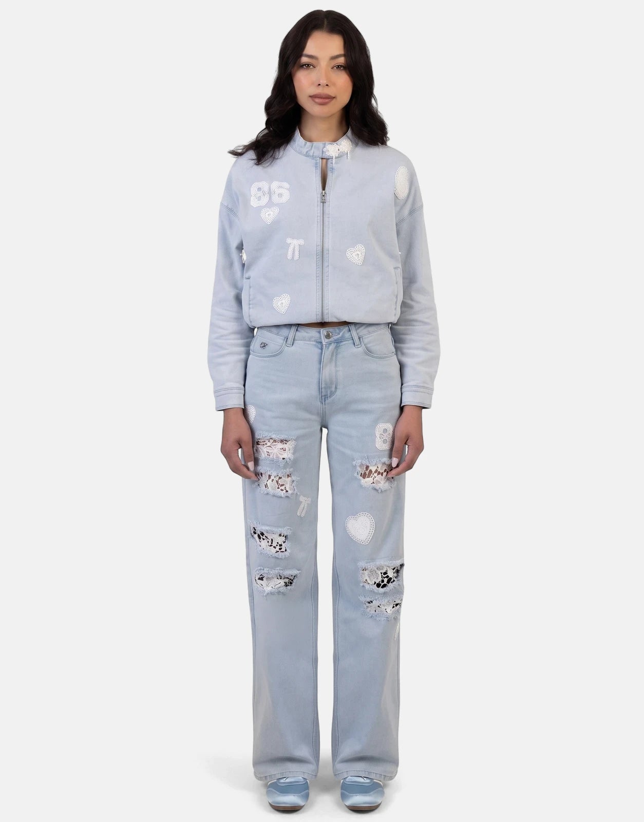 Full body shot of a woman wearing a light blue Sissy Boy Kiera Light Vintage Denim Bomber Jacket and matching distressed