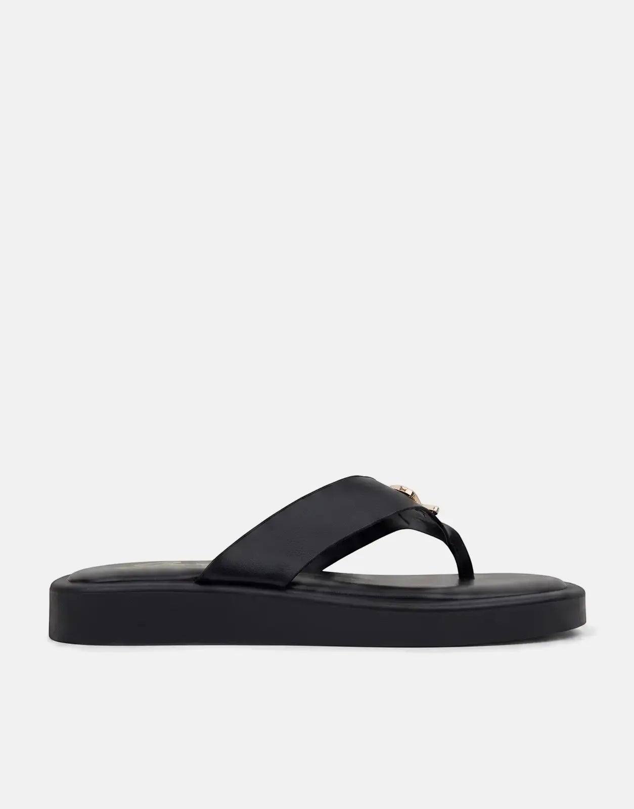 Black Sissy Boy Mimi thong sandals with a platform sole and gold buckle detail, presented in a side view.