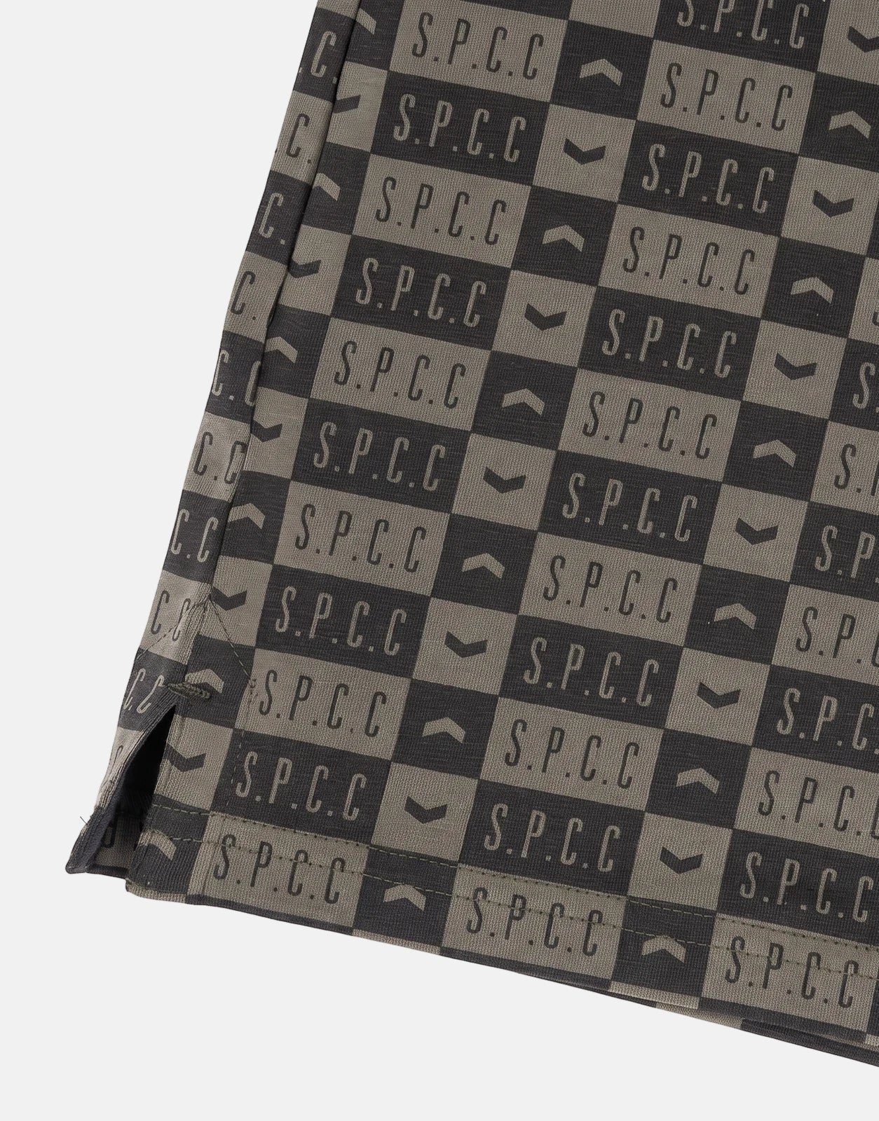 Close-up of SPCC Maro Fatigue Golfer in a dark grey and khaki checkerboard pattern with S.P.C.C. logos.