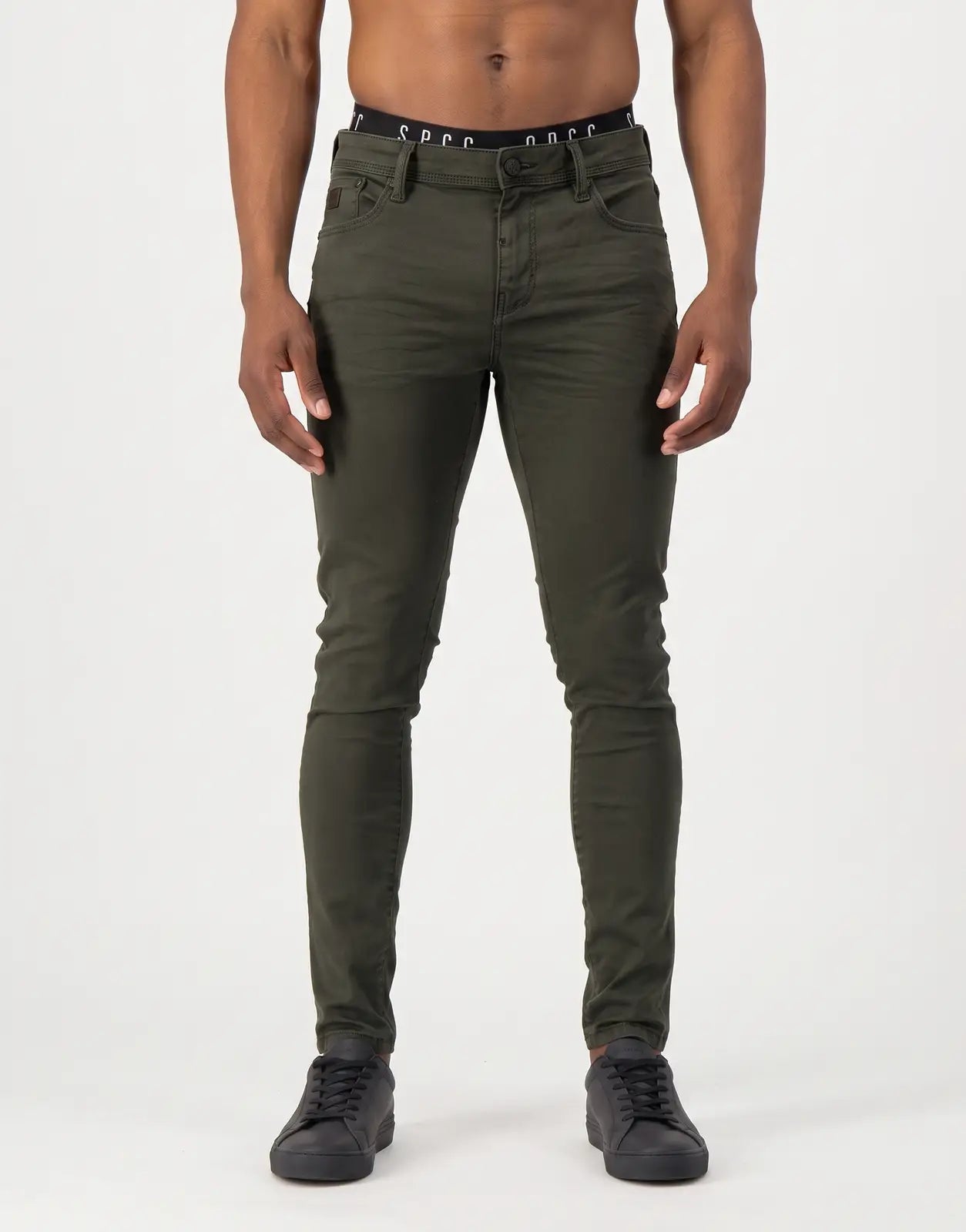SPCC Rodan Redrafted Fatigue Jeans for men, dark green, skinny fit, shown on a male model from the front.