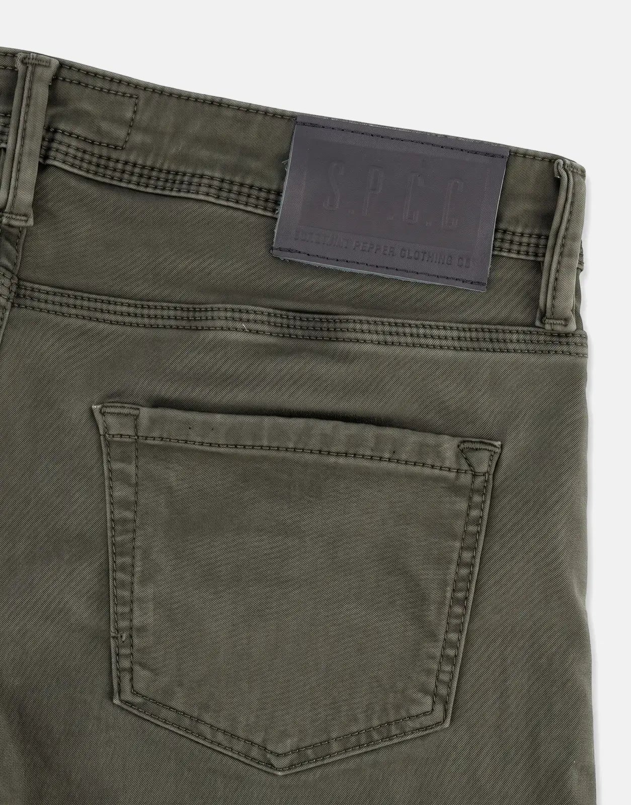 SPCC Rodan Redrafted Fatigue Jeans, close-up of the upper back with a black leather brand patch and pocket detail.