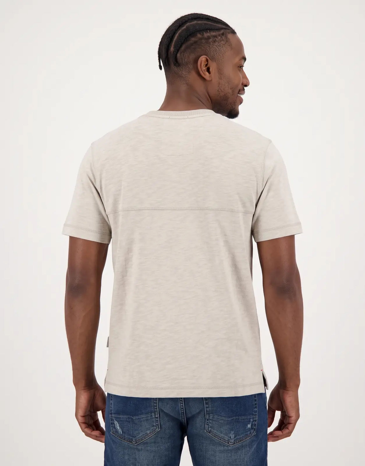 Back view of a men's SPCC Troy Tee in light beige, showcasing its textured fabric and short sleeves.