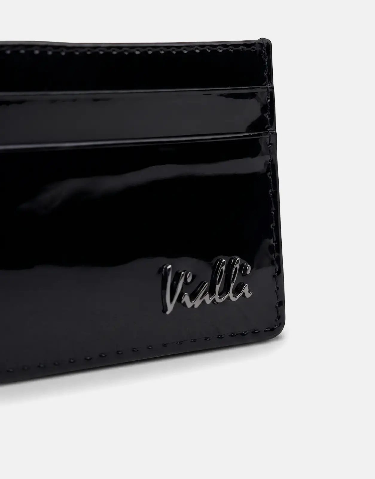 Close-up of a black patent leather Vialli Patern card holder with multiple slots and the Vialli logo, angled on a surface.